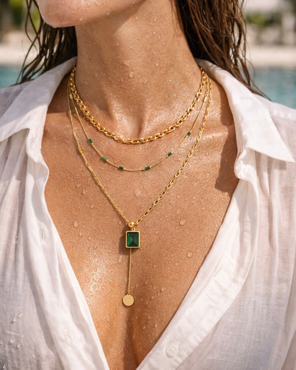 The intrigue stack a 3 chain necklace set on a model in the pool